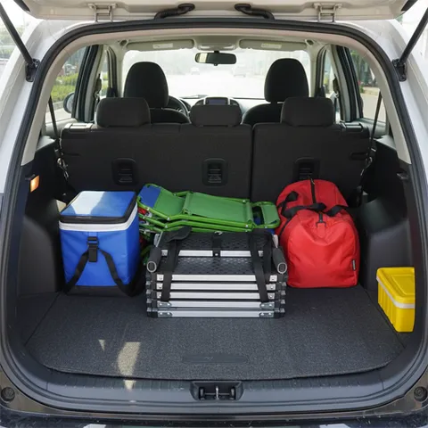 Folded DeerGym dog stairs stored in a car trunk showing compact and portable design